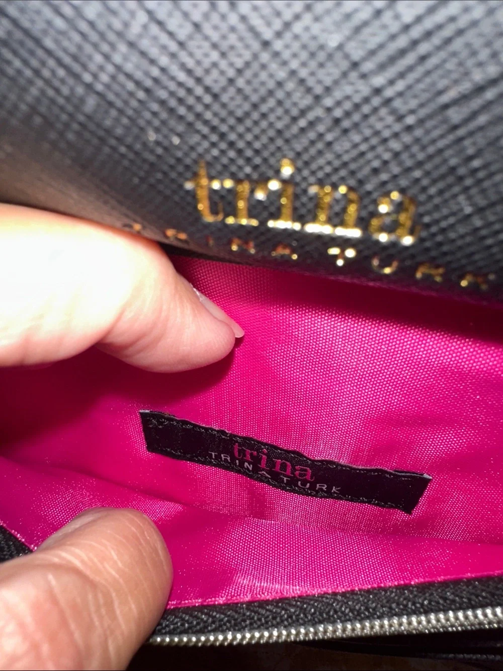 Trina Turk pink, red, black and blue cross body clutch with gold tone chain